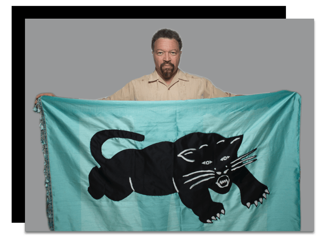 Charles ‘Cappy’ Pinderhughes holding a Black Panther flag